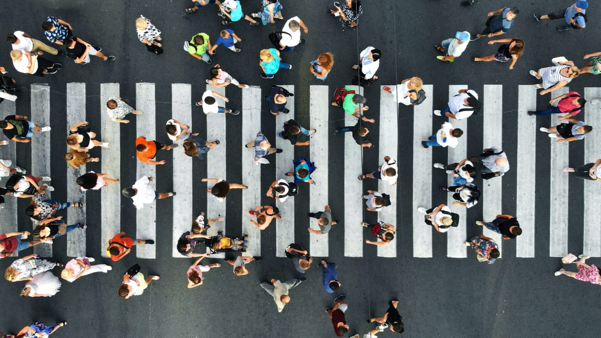 Aerial. Pedestrians on pedestrian crosswalk. Top view.